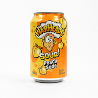 A 330mL can of Warheads Sour! Peach Soda, featuring a bright orange and yellow label with the brand's cartoon character and peach illustrations, set against a plain white background.
