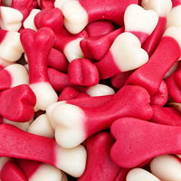 A close-up pile of red and white bone-shaped candies or gummy treats filling the frame.